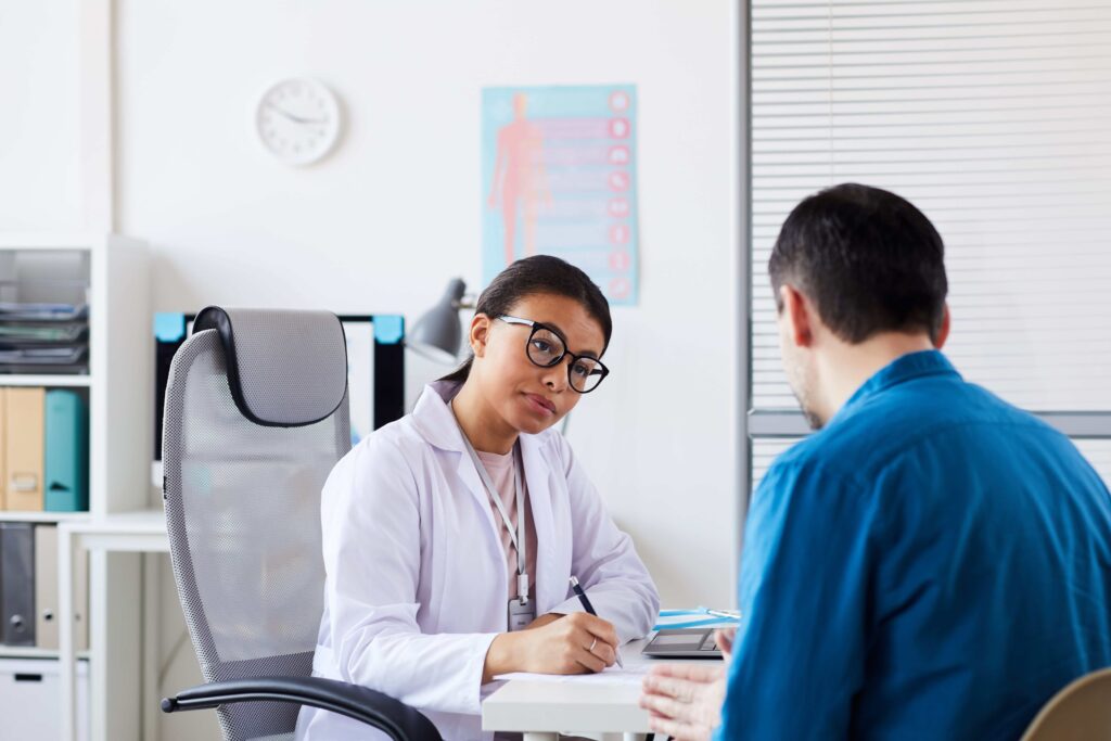 A patient consulting with a doctor at an urgent care clinic.