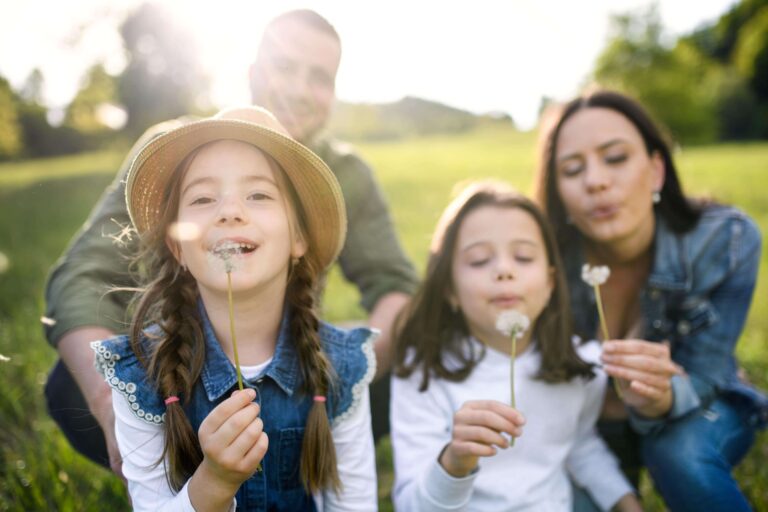 A family smiling outside, enjoying allergy-free time outdoors.