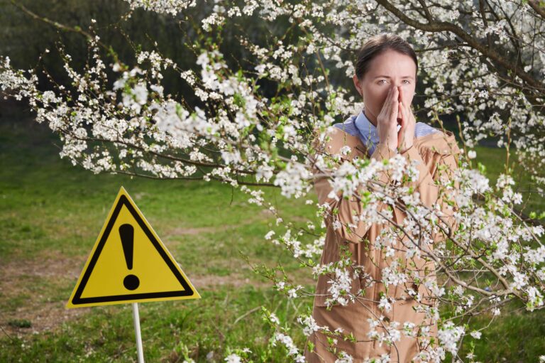 Woman allergic suffering from seasonal allergy at spring.