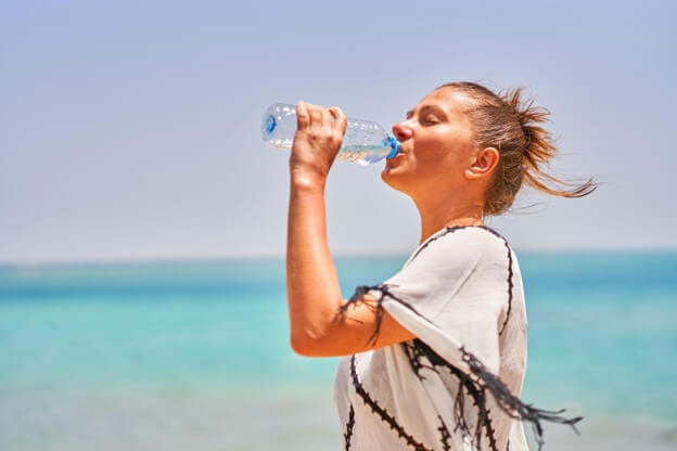 woman drinking water in warm day