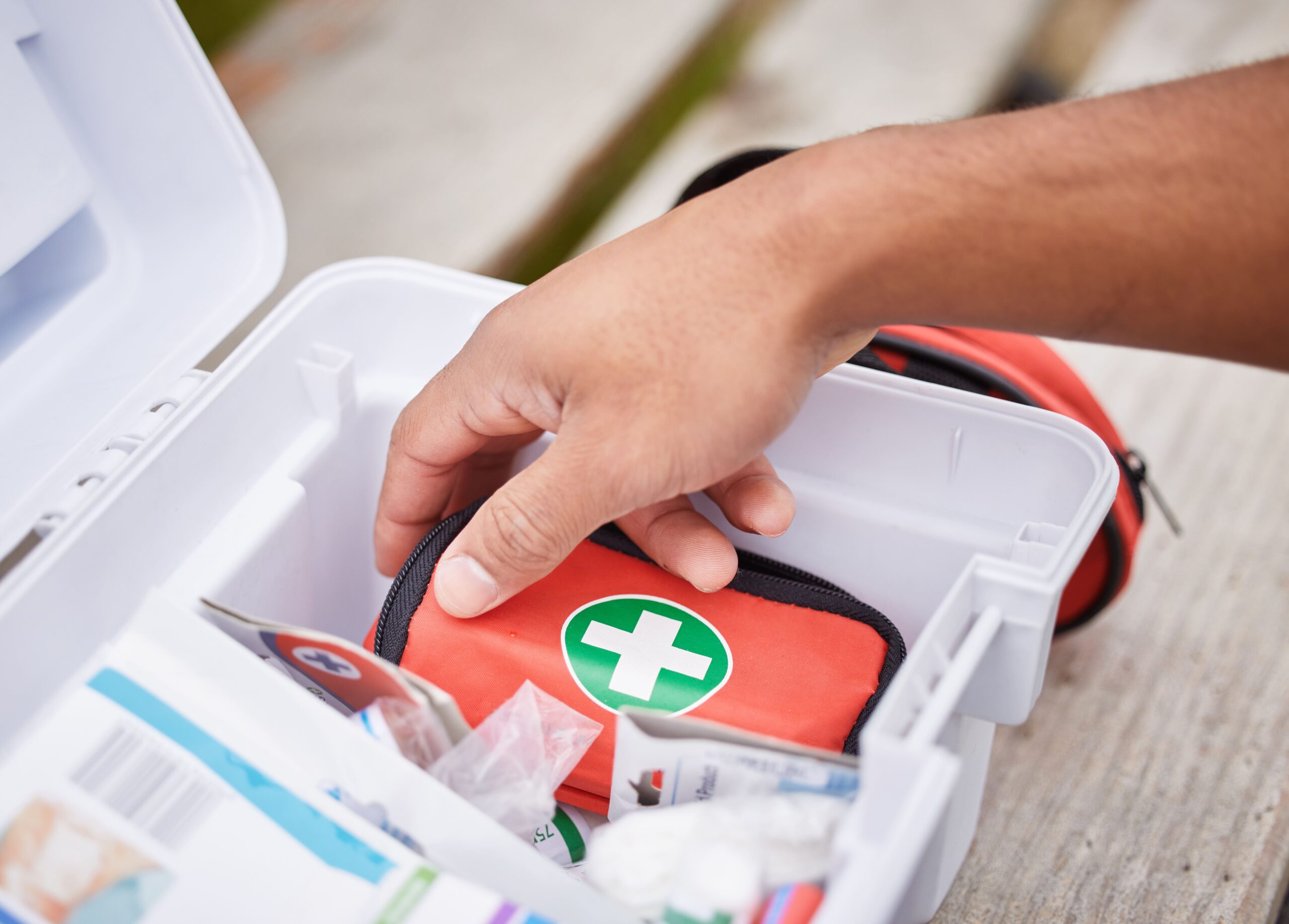 A travel or home kit with gauze, ointment, and bandages