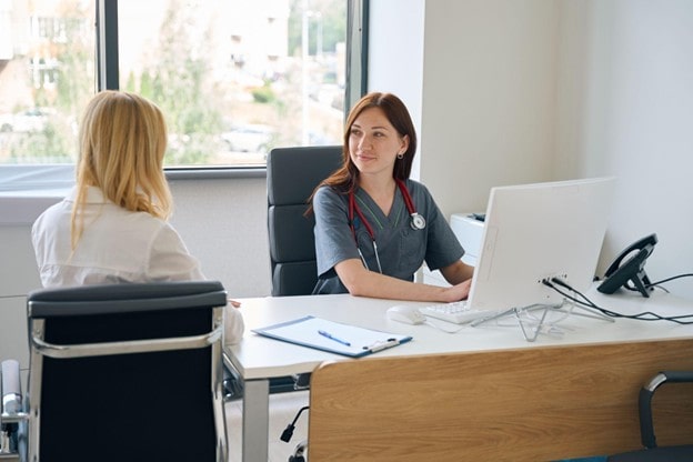 female doctor talking to a female patient