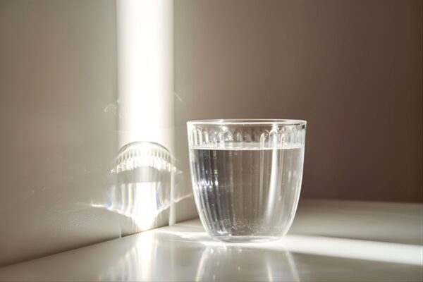 A glass of clean drinking water in the morning sun-min