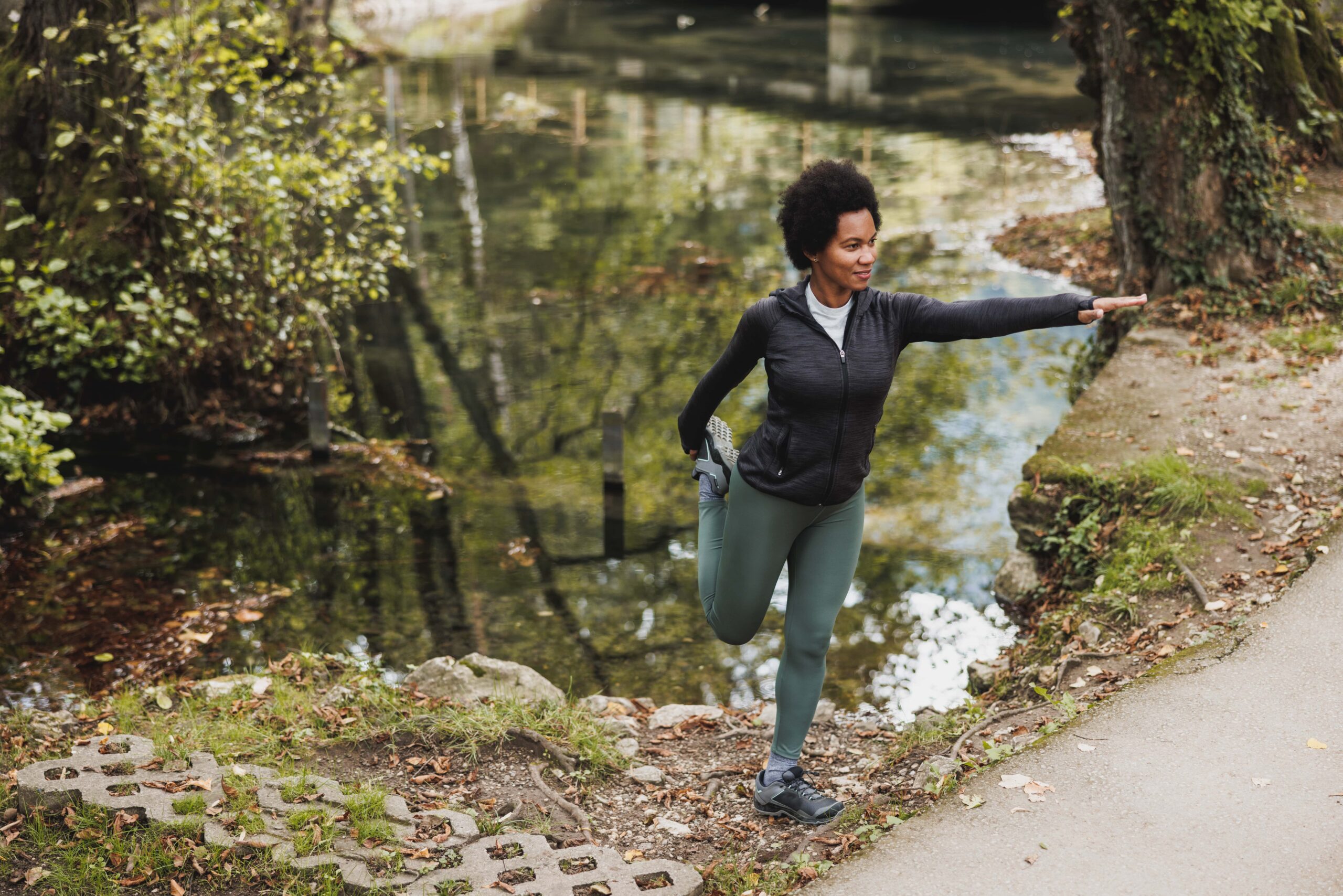 Black Woman Stretching After Running In Nature