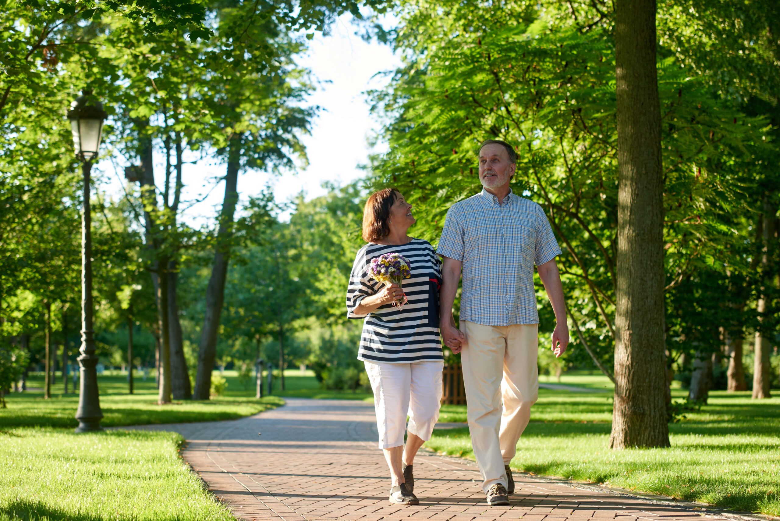 Shot of a walking mature caucasian couple in the park.