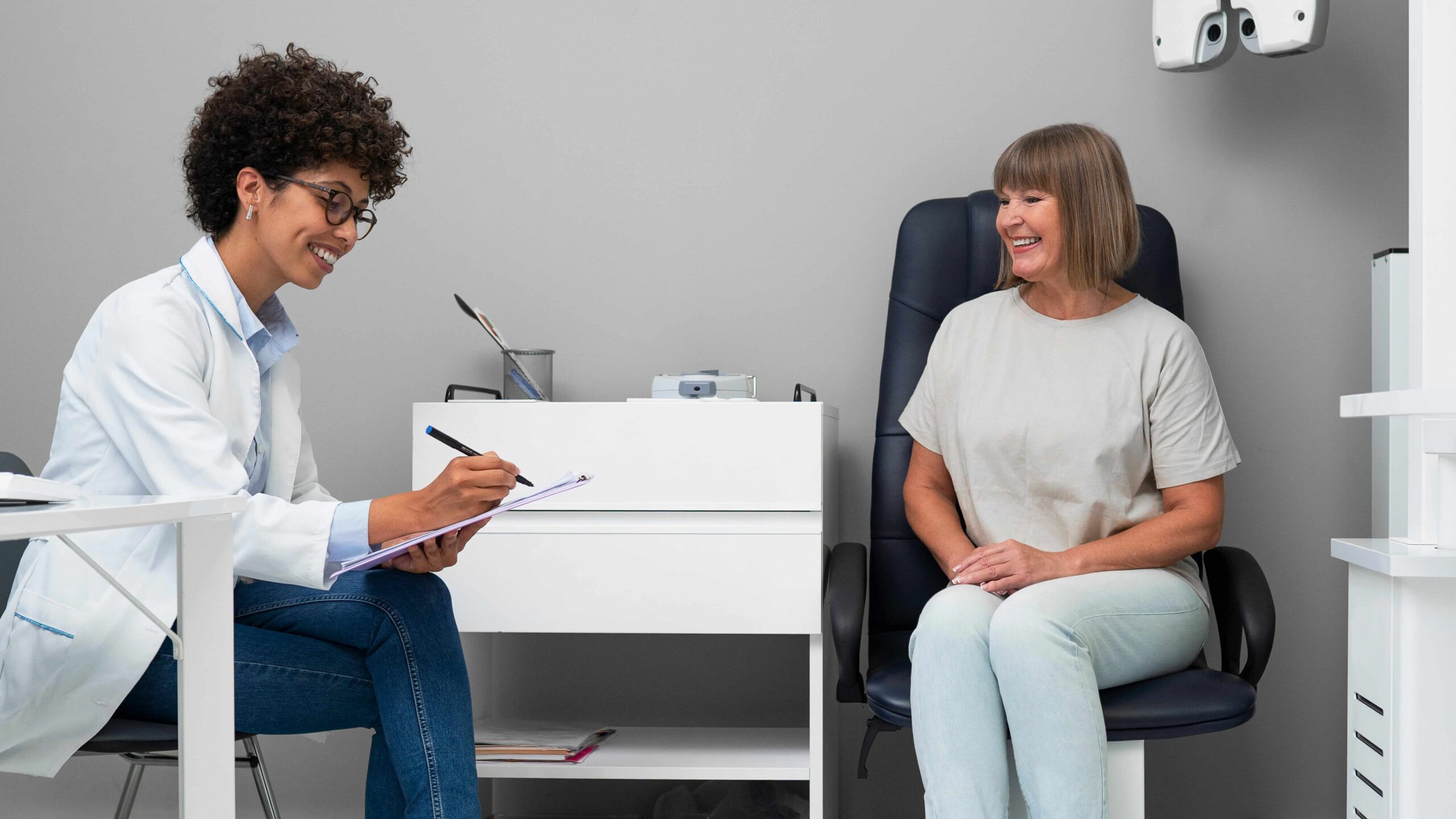 A woman doctor discusses patient care in the office.